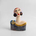 Modern woman with striking earrings and long eyelashes