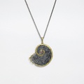 "Shell" silver pendant with gold inlay and small ruby