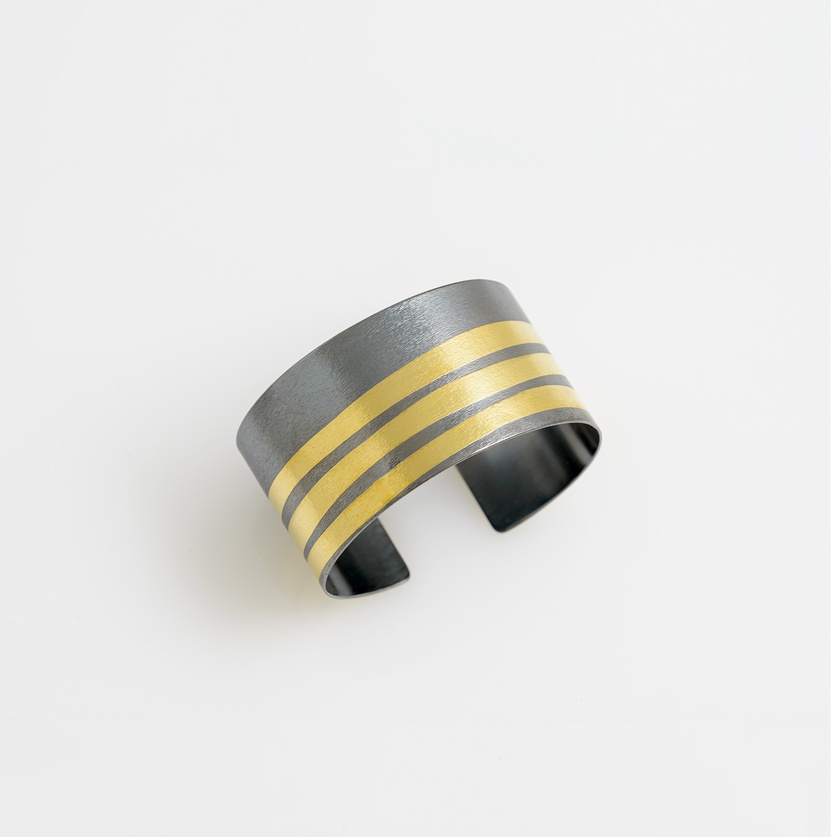 Impressive large bracelet in silver with stripes of gold