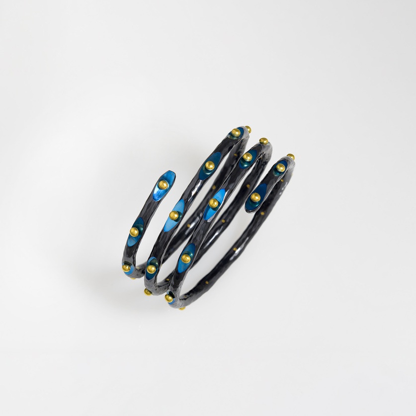 Titanium bracelet of intricate detail with gold