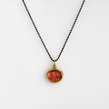 Silver and gold necklace with red tourmaline