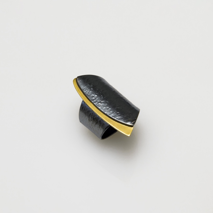 Silver ring in modern style with gold inlay