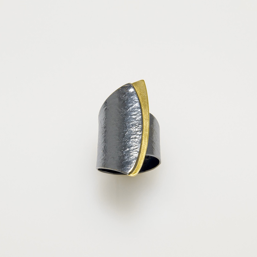 Silver ring in modern style with gold inlay