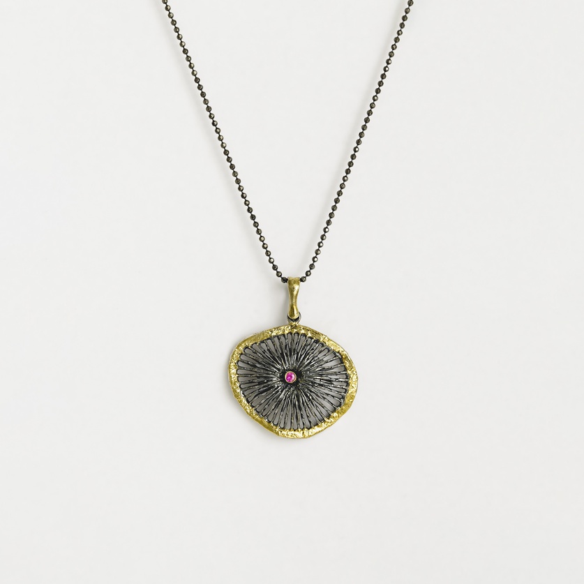 Embossed "Wheel" pendant in silver, gold inlay and ruby