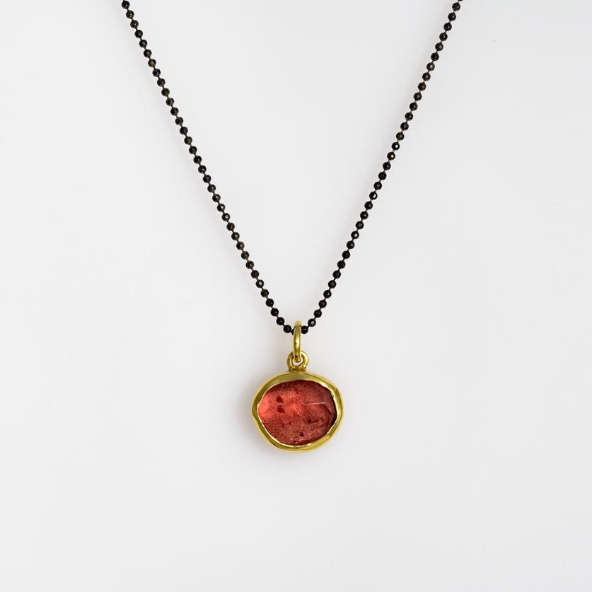 Silver and gold necklace with red tourmaline