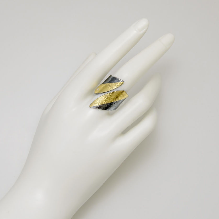 Silver ring in modern style with gold inlay and a small diamond