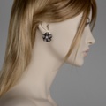 Flower-shaped stud earrings in black silver & pearls