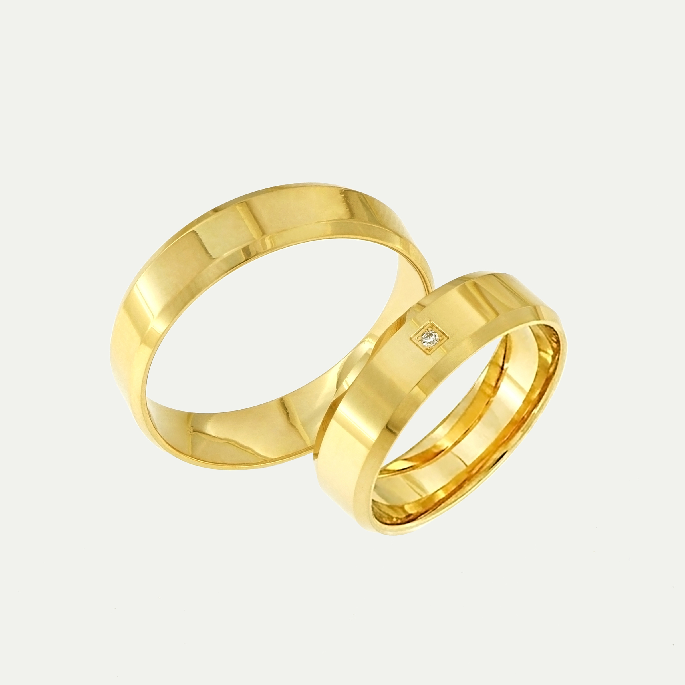 Gold wedding bands with a brilliant-cut diamond